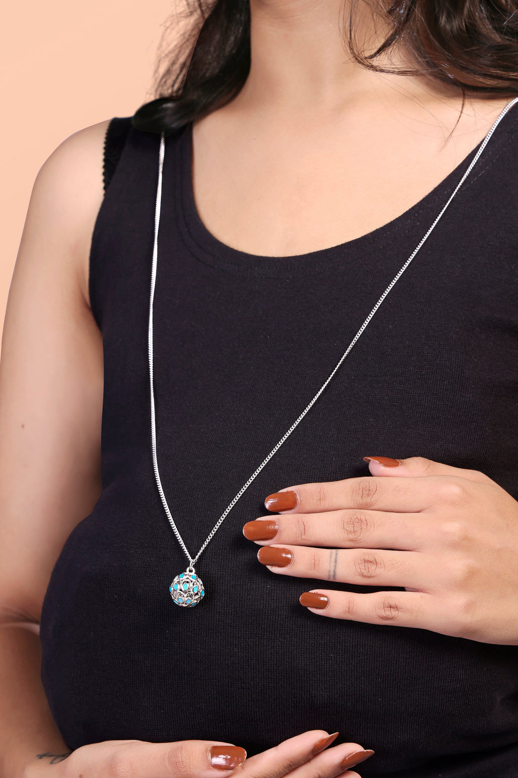 A 925 sterling silver harmony ball pregnancy necklace with a long chain, showing its detailed round chime pendant.