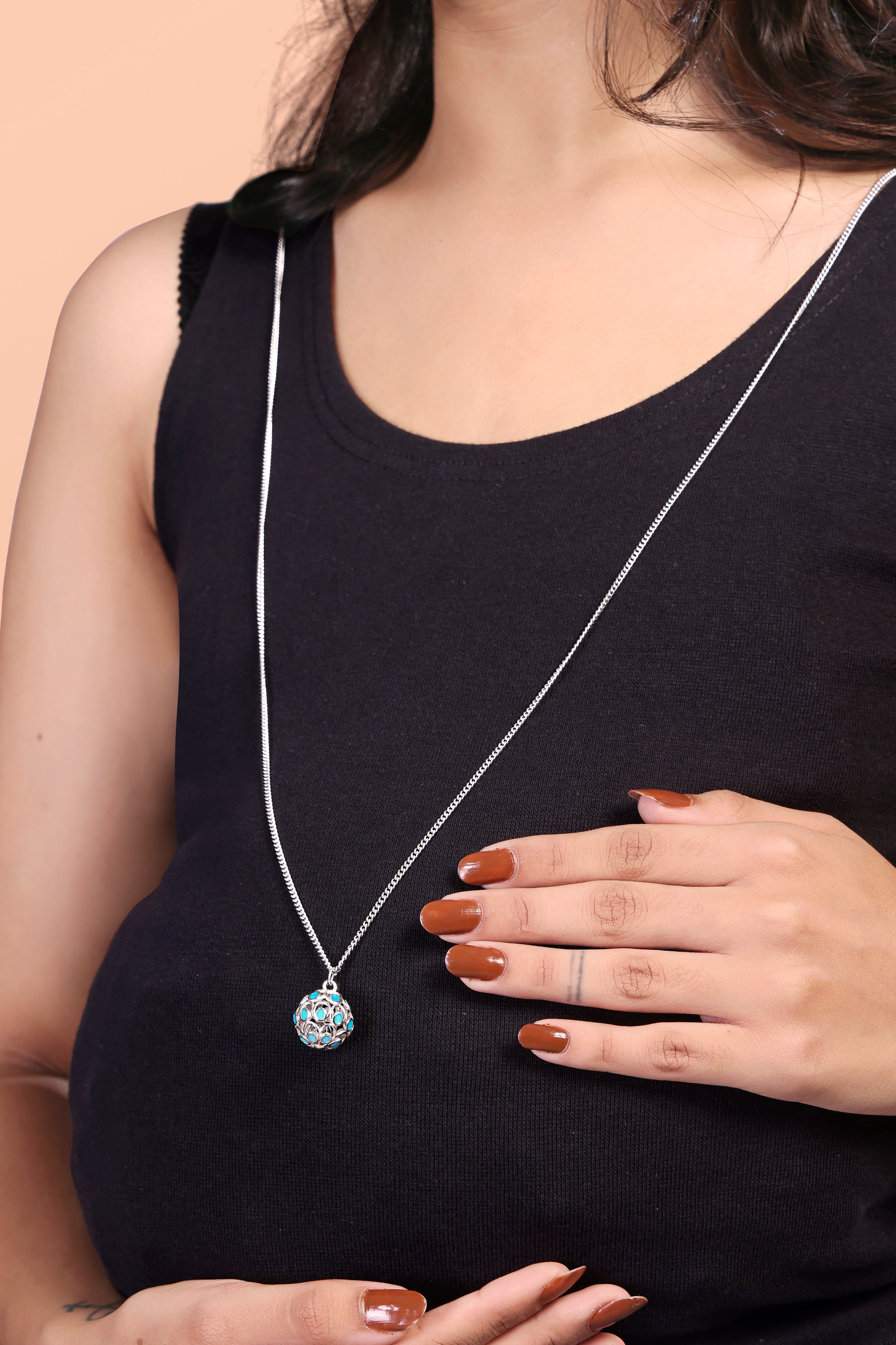A 925 sterling silver harmony ball pregnancy necklace with a long chain, showing its detailed round chime pendant.