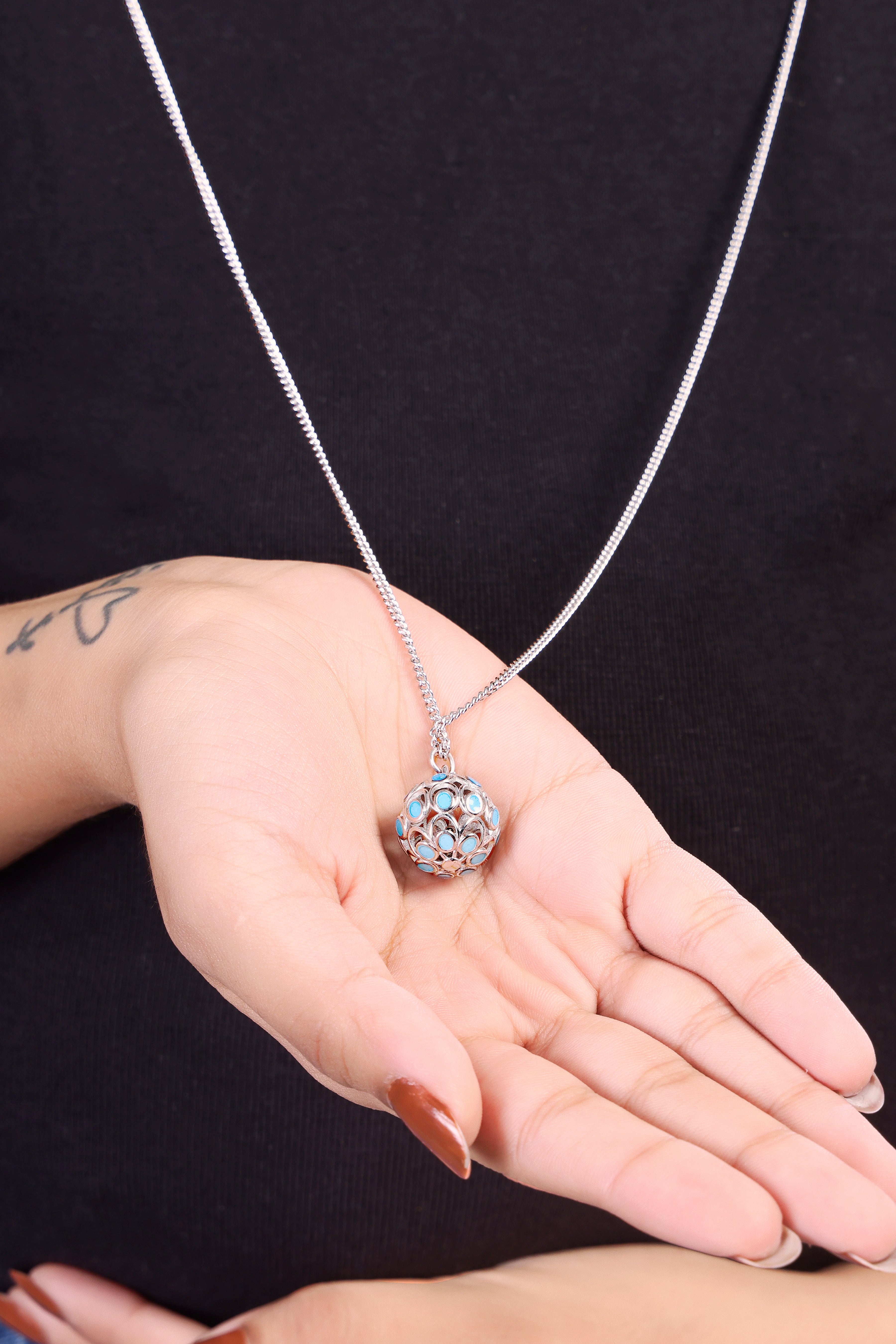 Close-up view of the polished 925 silver harmony ball necklace, highlighting the intricate design on the pendant.