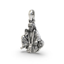 An angled side profile of the religious Sai Baba silver pendant, showcasing its intricate details and sterling silver
