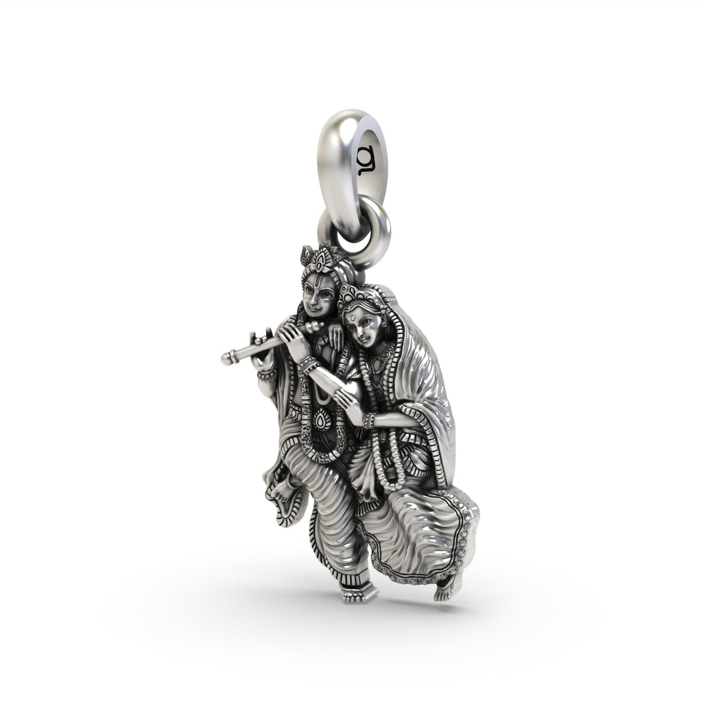 Angled view of the silver Radha Krishna pendant, highlighting the depth and intricate craftsmanship of the design.