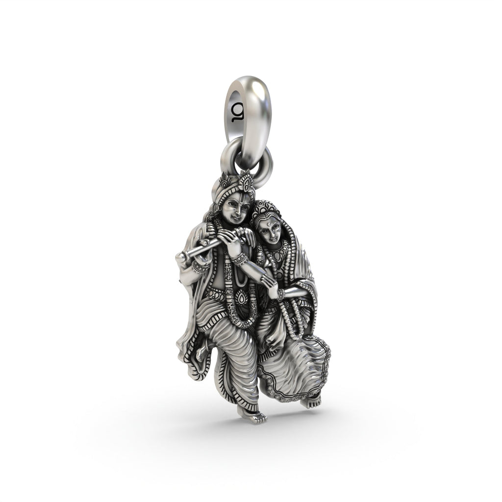 A close-up of the silver Radha Krishna pendant, focusing on the antique oxidized finish and serene expressions.