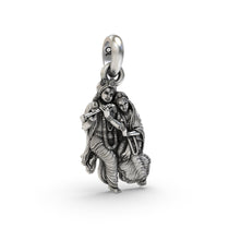 A close-up of the silver Radha Krishna pendant, focusing on the antique oxidized finish and serene expressions.