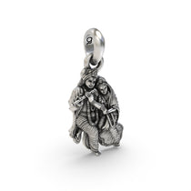 The silver Radha Krishna pendant held in hand to show its scale and hollow back design for lightweight comfort.