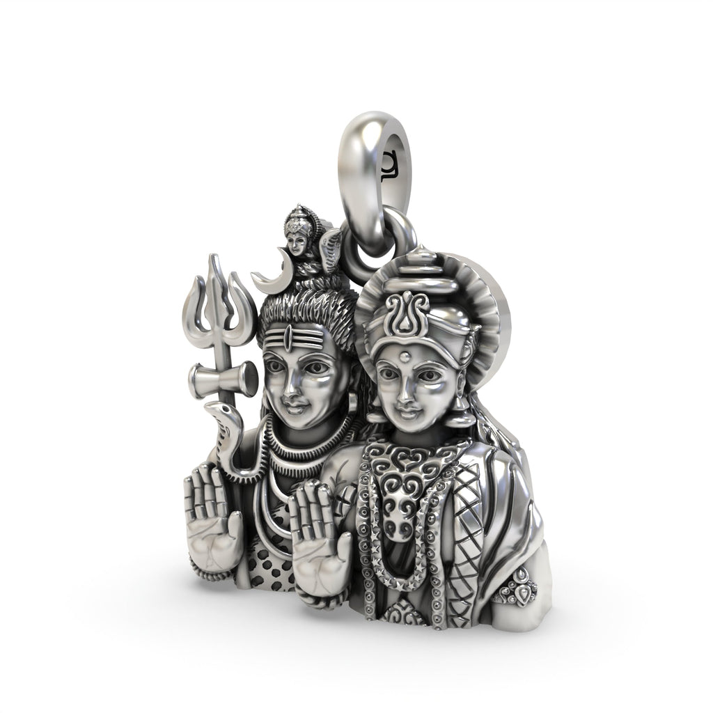 Angled shot of the silver Shiv Parvati pendant, highlighting the intricate craftsmanship and antique oxidized texture.