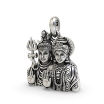 Angled shot of the silver Shiv Parvati pendant, highlighting the intricate craftsmanship and antique oxidized texture.