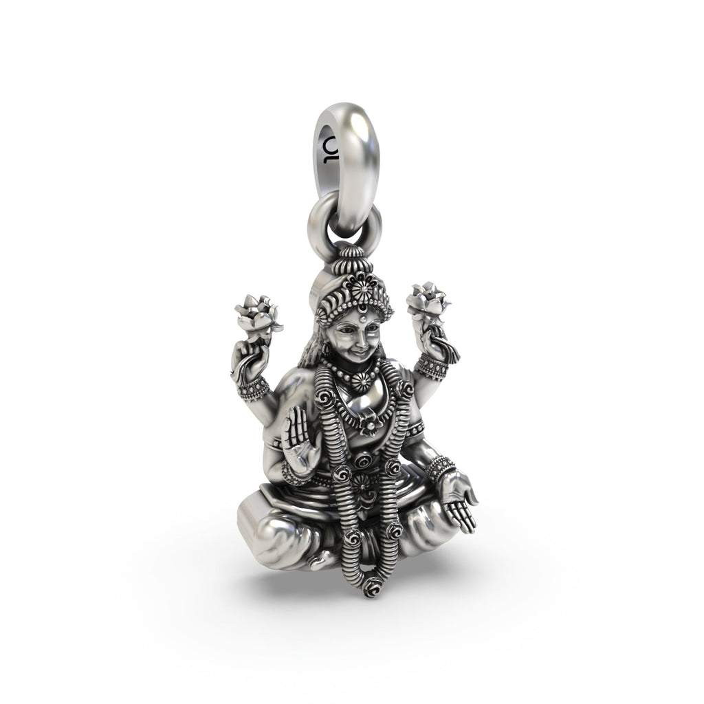 The sterling silver Lakshmi pendant shown for scale, a sacred emblem of prosperity with an elegant oxidized finish.