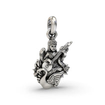 A detailed close-up of the sterling silver Saraswati Maa pendant, highlighting the antique oxidized finish on the carving.