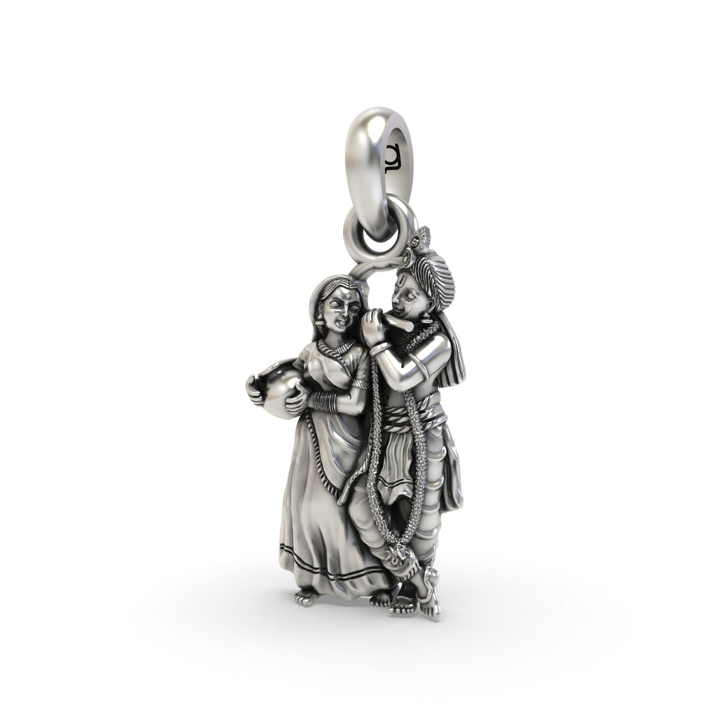 Close-up detail of the intricate carvings on the Radha Krishna 925 oxidized silver pendant, showing their divine forms.