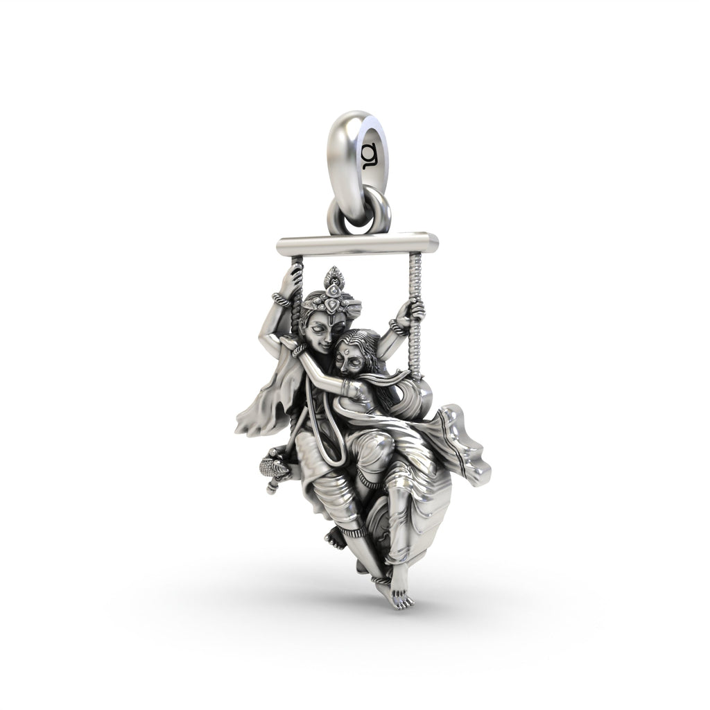 Angled profile of the oxidized Radha Krishna on a swing pendant, highlighting the fine craftsmanship and hollow back design.