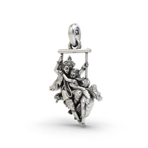 Angled profile of the oxidized Radha Krishna on a swing pendant, highlighting the fine craftsmanship and hollow back design.