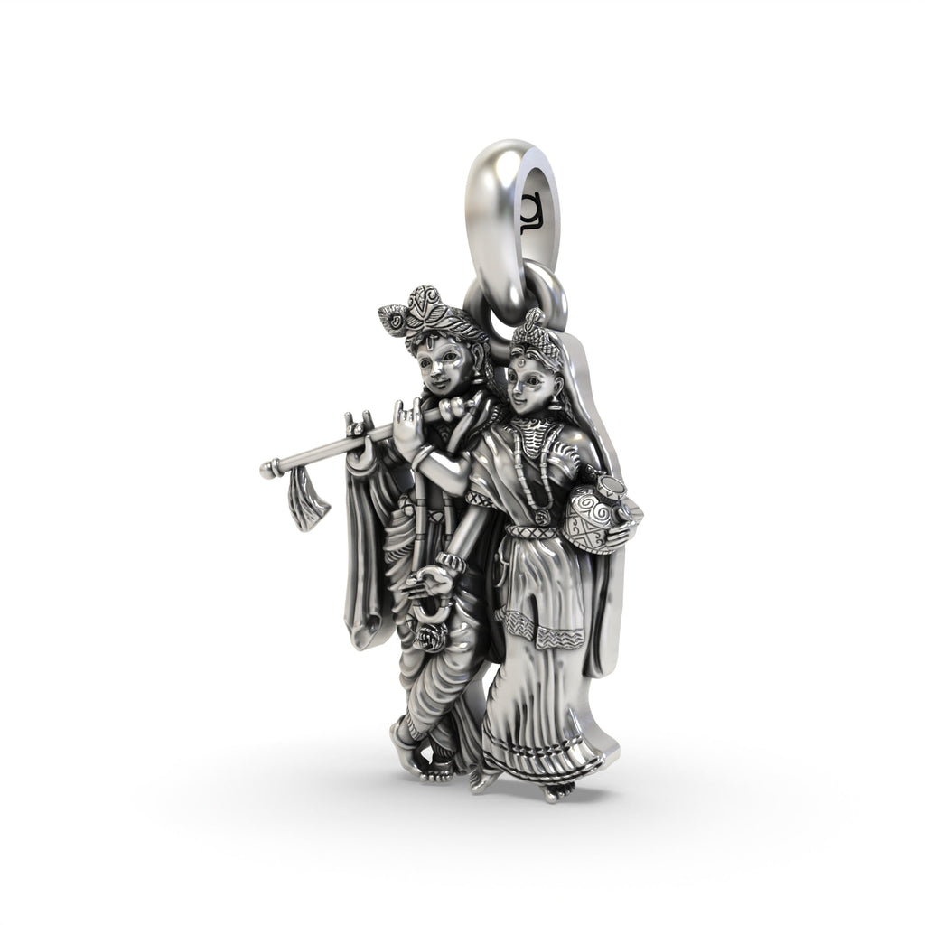 An angled view of the Radha Krishna silver pendant highlighting the intricate details and fine craftsmanship from Alankar.