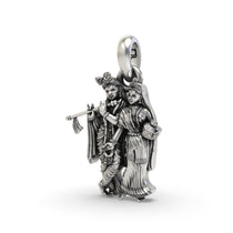 An angled view of the Radha Krishna silver pendant highlighting the intricate details and fine craftsmanship from Alankar.
