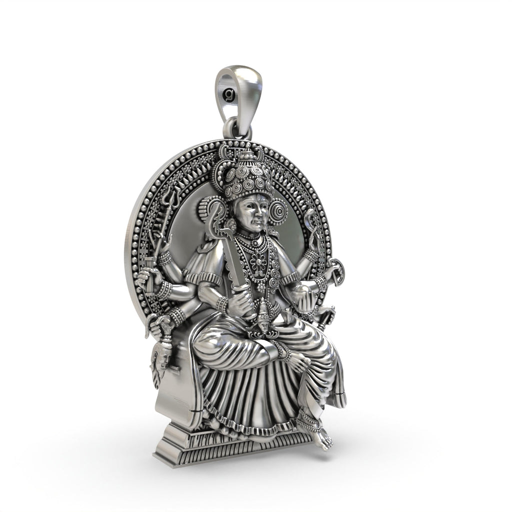 Close-up detail on the face of the Kodungallur Bhagavathy Amma silver pendant with an antique oxidized finish.