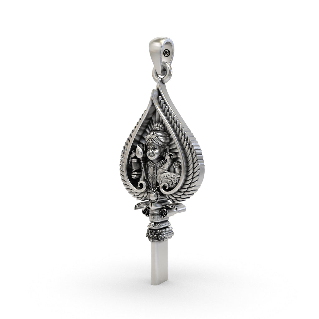 A close-up detail shot of the Murugan face on the 925 silver Vel spear amulet, highlighting the antique texture.