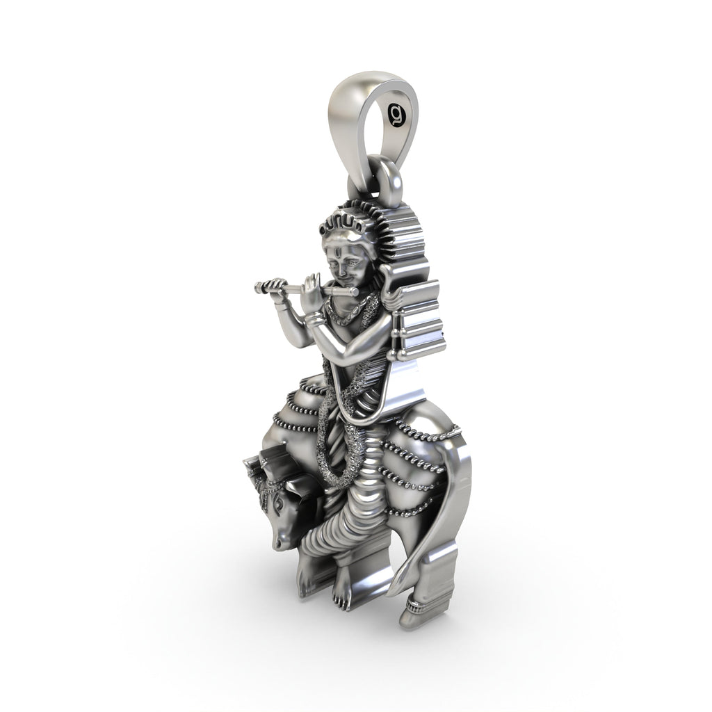 A 20mm 925 Silver Krishna with Cow pendant shown for scale, highlighting its intricate details and traditional look.
