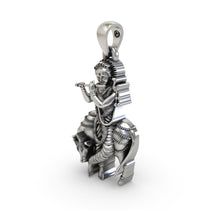 A 20mm 925 Silver Krishna with Cow pendant shown for scale, highlighting its intricate details and traditional look.