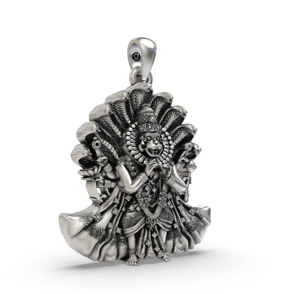 Close-up detail of the fierce expression on the Narsimha Bhagwan silver pendant, emphasizing the antique oxidized texture.