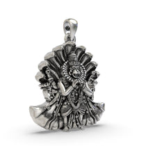 Close-up detail of the fierce expression on the Narsimha Bhagwan silver pendant, emphasizing the antique oxidized texture.
