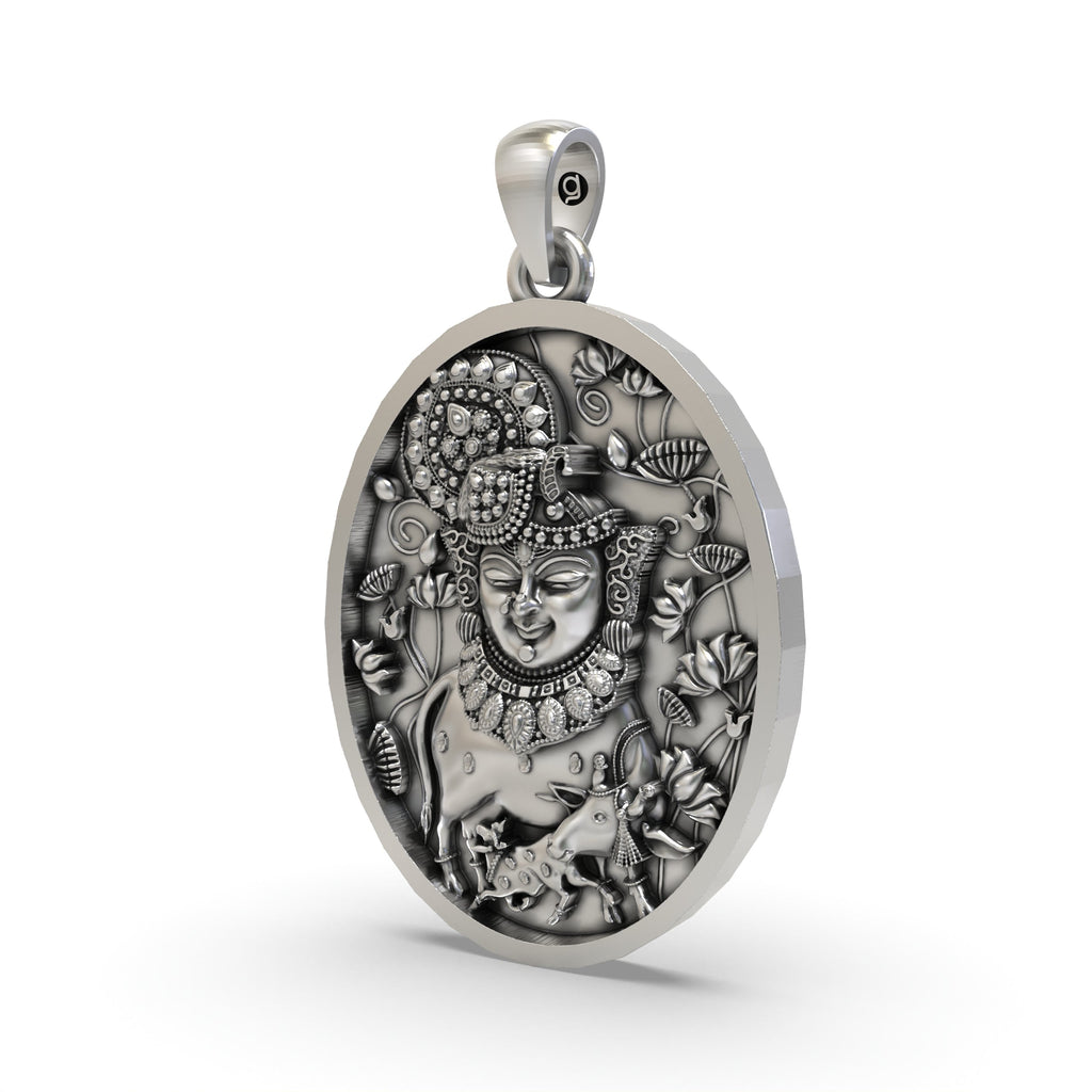 Angled view of the handcrafted Shreenathji face pendant in 925 sterling silver showing its side profile.
