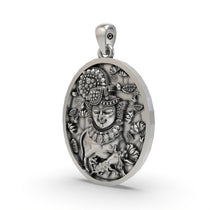 Angled view of the handcrafted Shreenathji face pendant in 925 sterling silver showing its side profile.