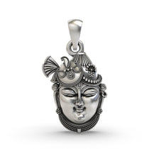 Front view of the intricately detailed Shrinathji Face Pendant in oxidized 925 sterling silver on a white surface.