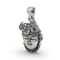 The sterling silver Shrinathji Krishna pendant held in hand to show its divine form, size, and lightweight design.