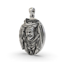 Angled view of the Lord Kaal Bhairav amulet, highlighting the intricate details and oxidized 925 silver finish.
