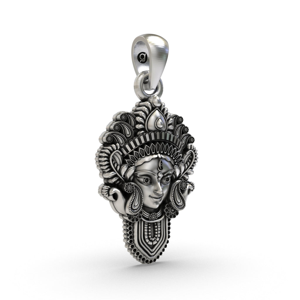 Close-up detail of the Durga Maa face pendant in oxidized sterling silver, showing the serene yet fierce expression of the