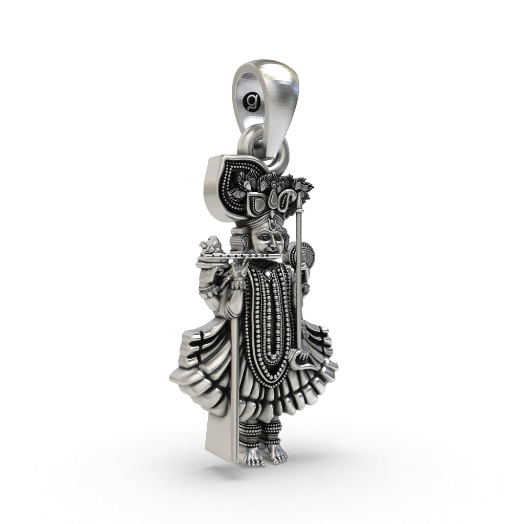 Angled side profile of the Dakor Krishna Ranchhodraiji silver pendant, revealing its depth and antique oxidized finish.