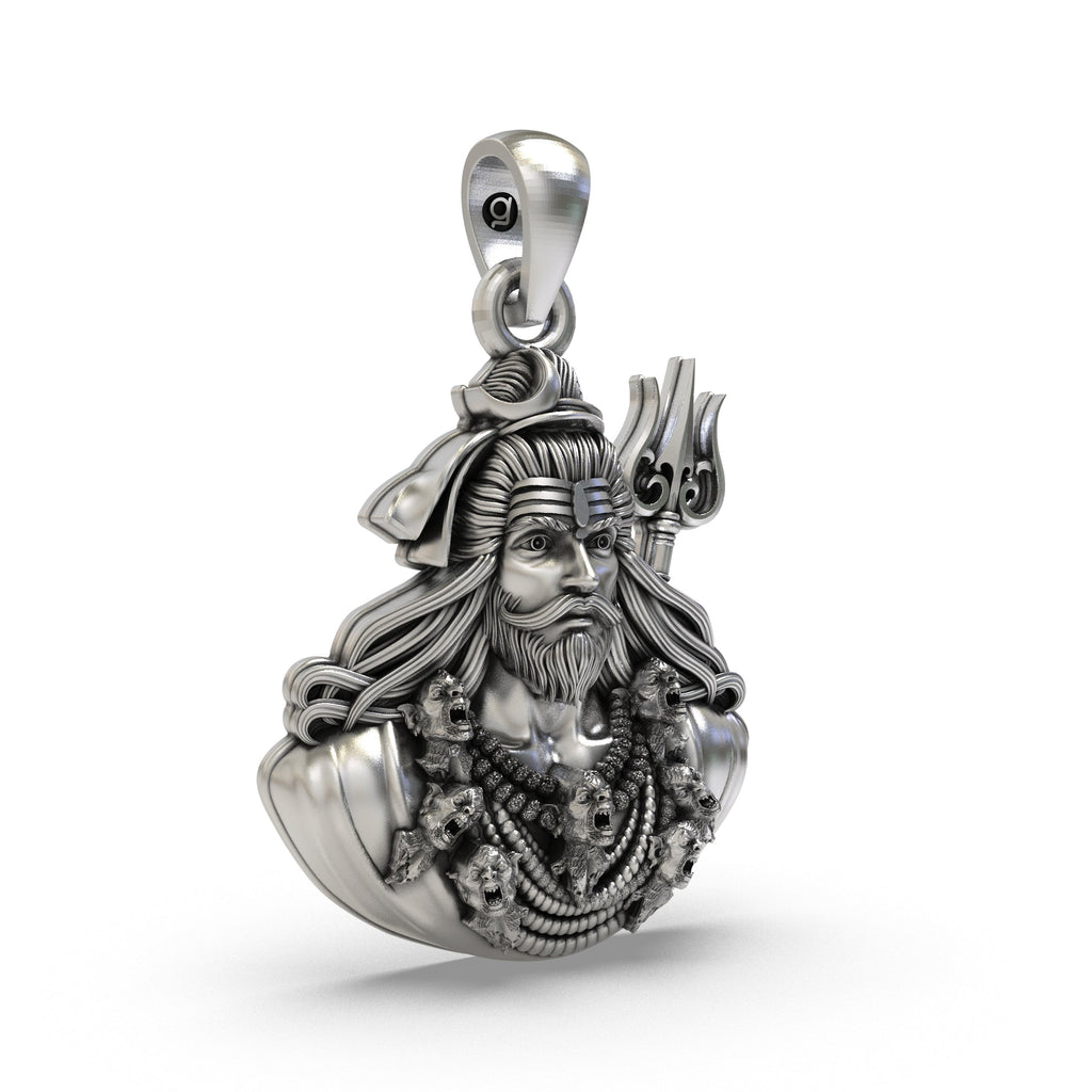 Close-up of the antique oxidized finish on the sterling silver Shivji face amulet, showing its texture and depth.