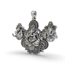 A close-up angled shot of the Three Ganesha Pendant, highlighting the oxidized 925 silver finish and craftsmanship.