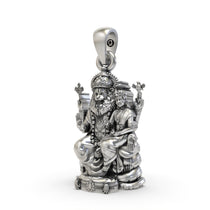 Close-up detail of the handmade Lakshmi Narasimha silver pendant showing intricate carvings.