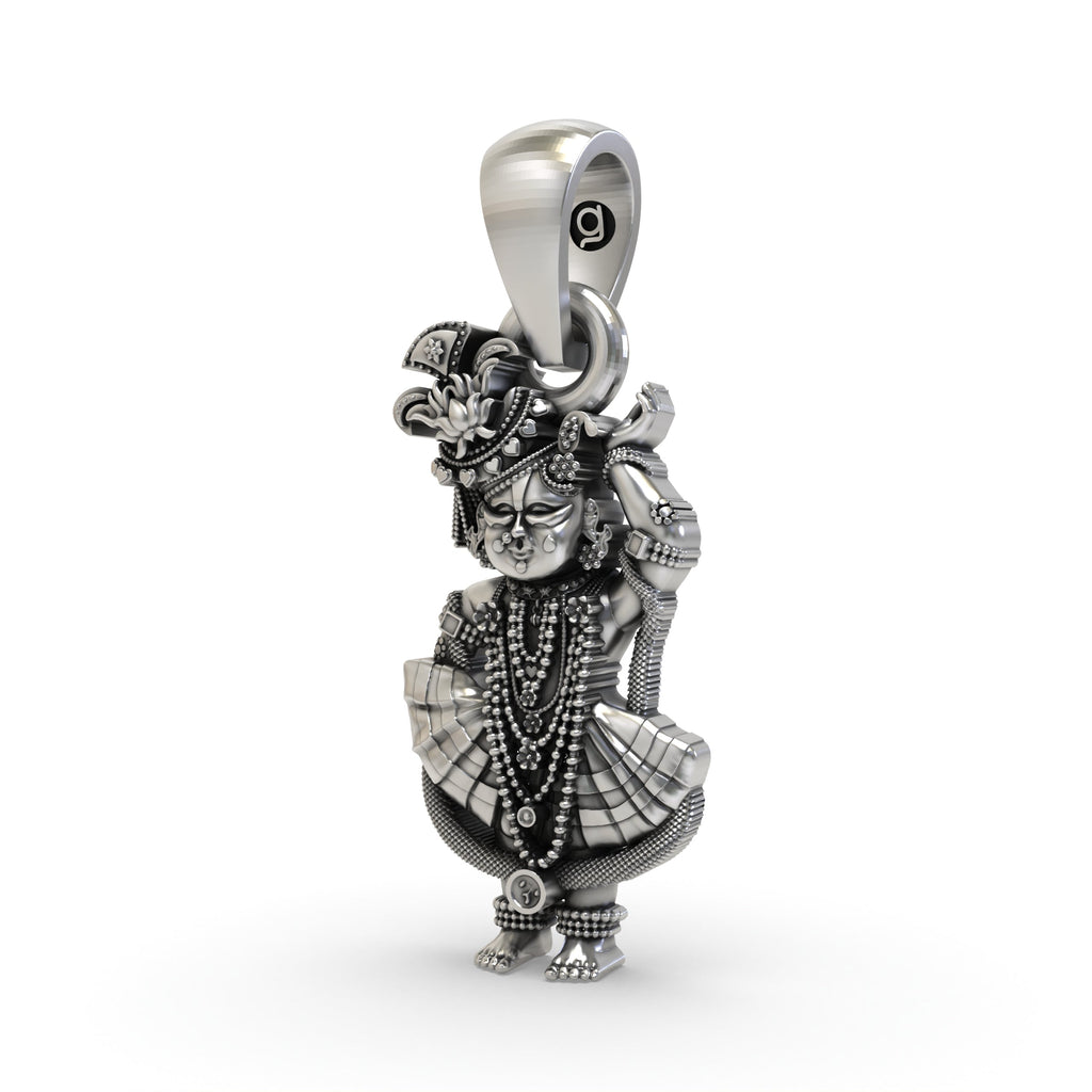 Close-up of the pure 925 sterling silver Shri Girdhar Lal Ji spiritual amulet and texture.
