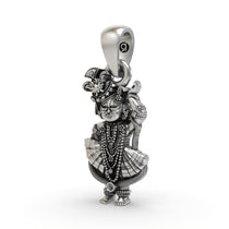 Close-up of the pure 925 sterling silver Shri Girdhar Lal Ji spiritual amulet and texture.