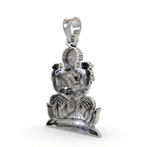 The 925 sterling silver Lakshmi Maa pendant held in hand to showcase its size, scale, and beautiful finish.