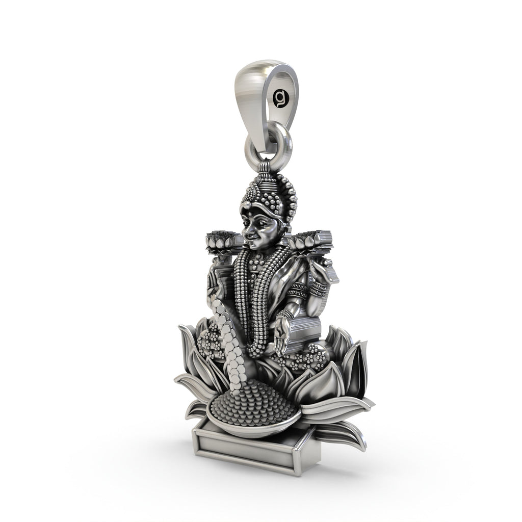 The sterling silver Lakshmi Maa pendant shown for size reference, a perfect spiritual keepsake for prosperity.
