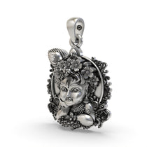 Angled profile view of the 925 silver Bal Krishna face pendant, highlighting the intricate floral details.