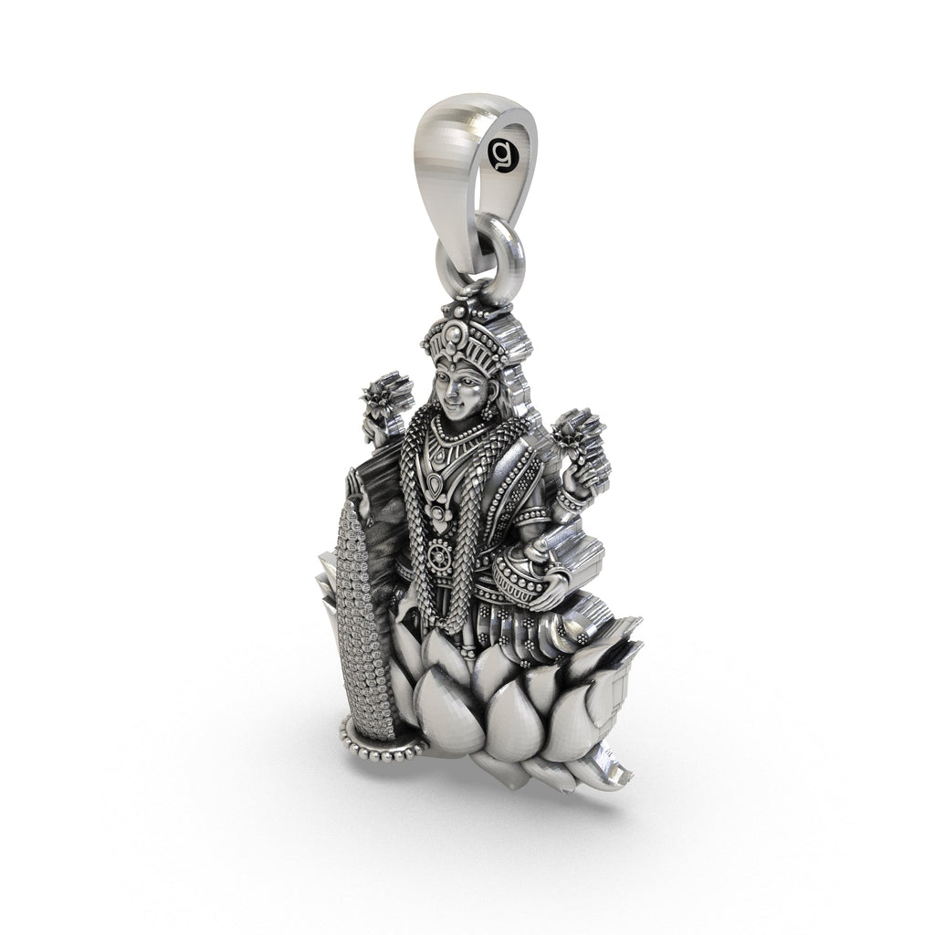 The 925 sterling silver Lakshmi Maa pendant held to show its size and unique handcrafted finish.