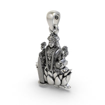 The 925 sterling silver Lakshmi Maa pendant held to show its size and unique handcrafted finish.