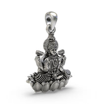 Close-up detail of the Goddess Lakshmi's face on the handmade silver lotus pendant, a piece of Hindu spiritual jewelry.