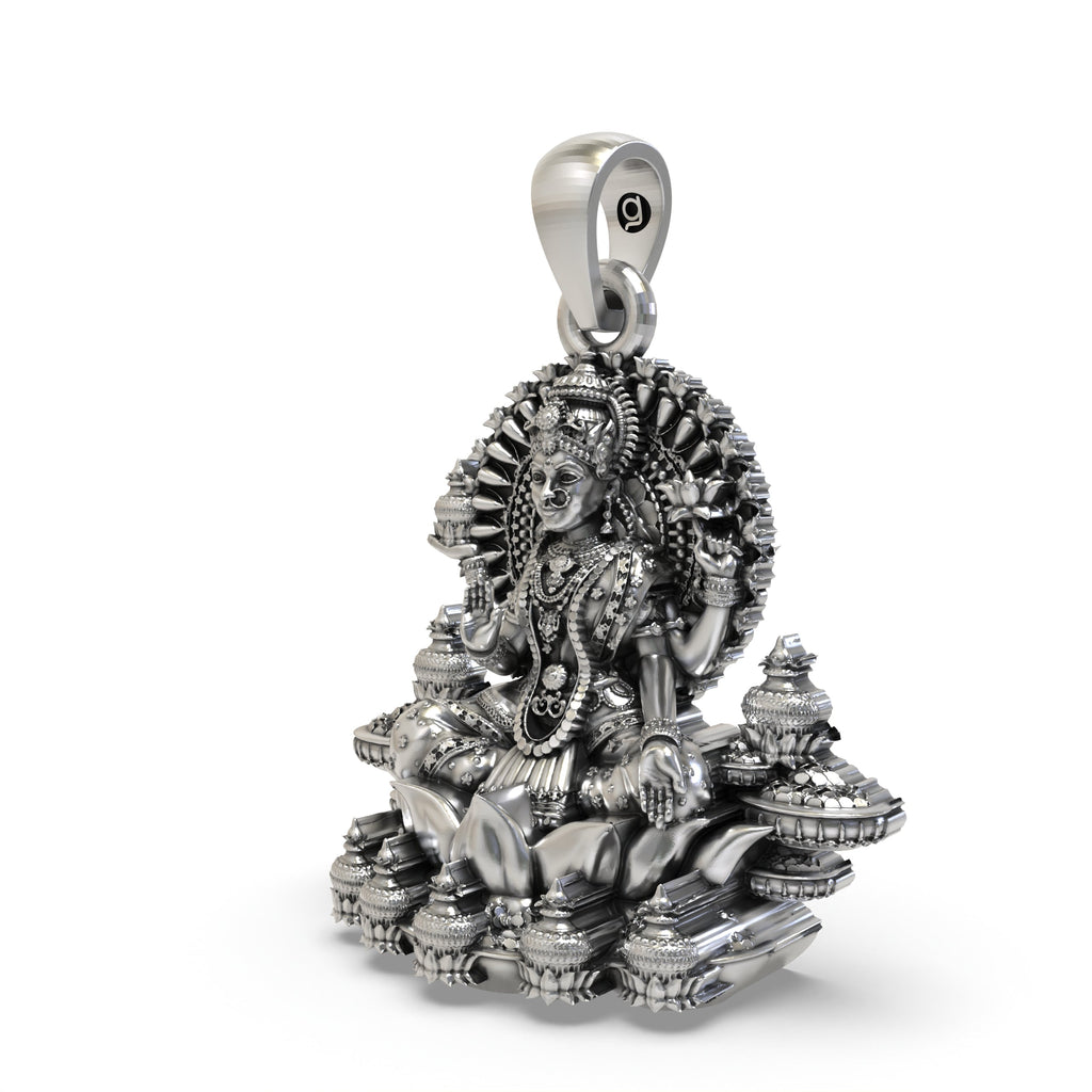 Close-up detail of the intricate handmade temple jewelry craftsmanship on the silver Lakshmi pendant.