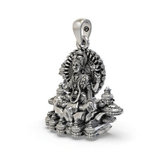Close-up detail of the intricate handmade temple jewelry craftsmanship on the silver Lakshmi pendant.