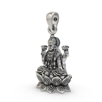 Close-up detail of handcrafted silver Mahalakshmi pendant showing the blessing mudra.