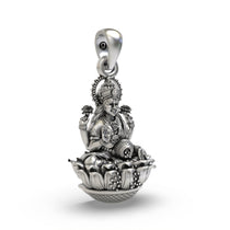 Side profile of the sterling silver Lakshmi Devi charm highlighting the beautiful artisanal finish.