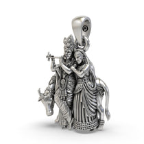 Close-up of the sterling silver Radha Krishna locket showing the sacred cow and Lord Krishna with his flute.