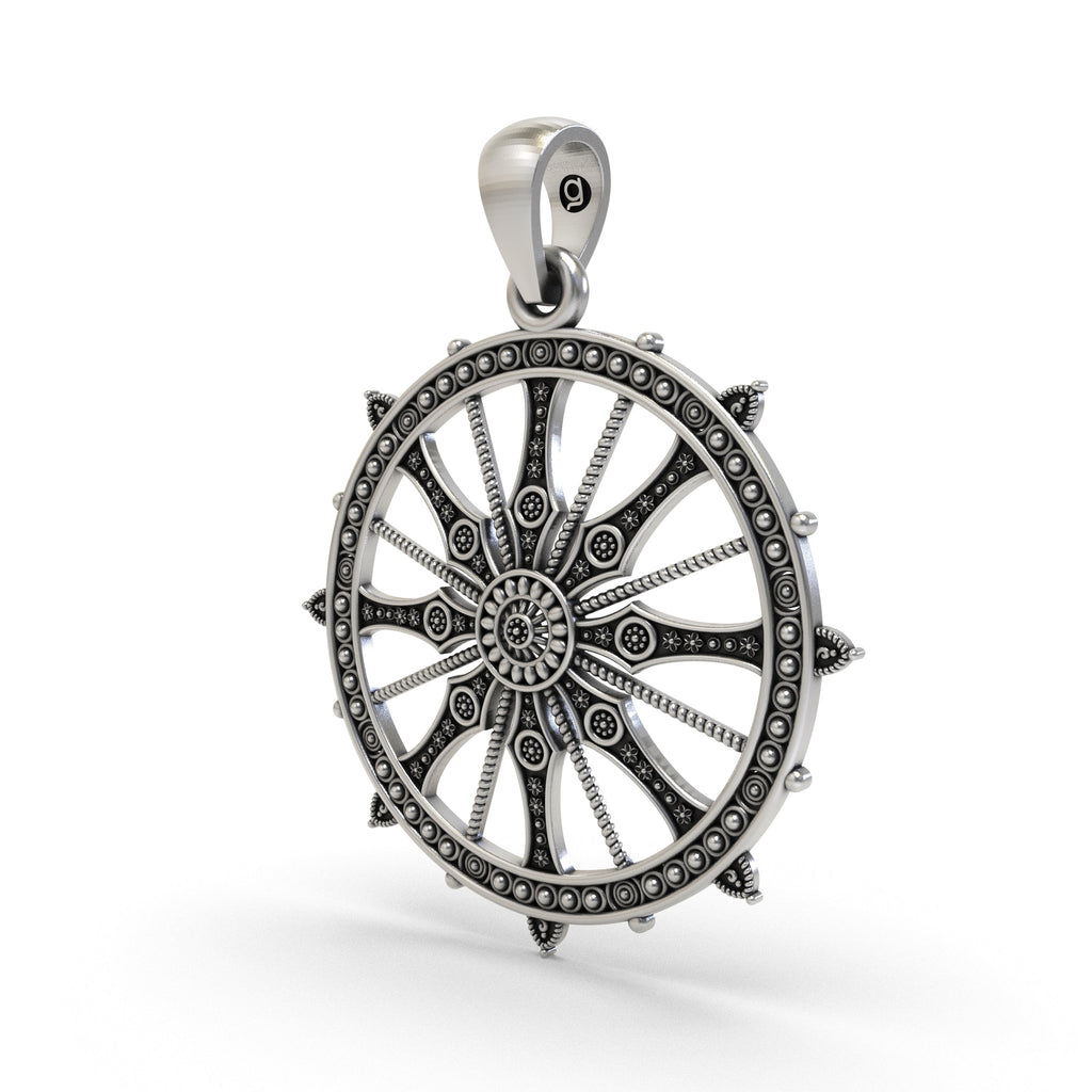 Close-up of the antique oxidized finish on the sterling silver Konark Sun Wheel pendant.