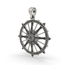 Close-up of the antique oxidized finish on the sterling silver Konark Sun Wheel pendant.