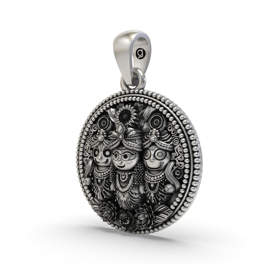 Close-up detailing the carved trio of Lord Jagannath on this sterling silver medallion.