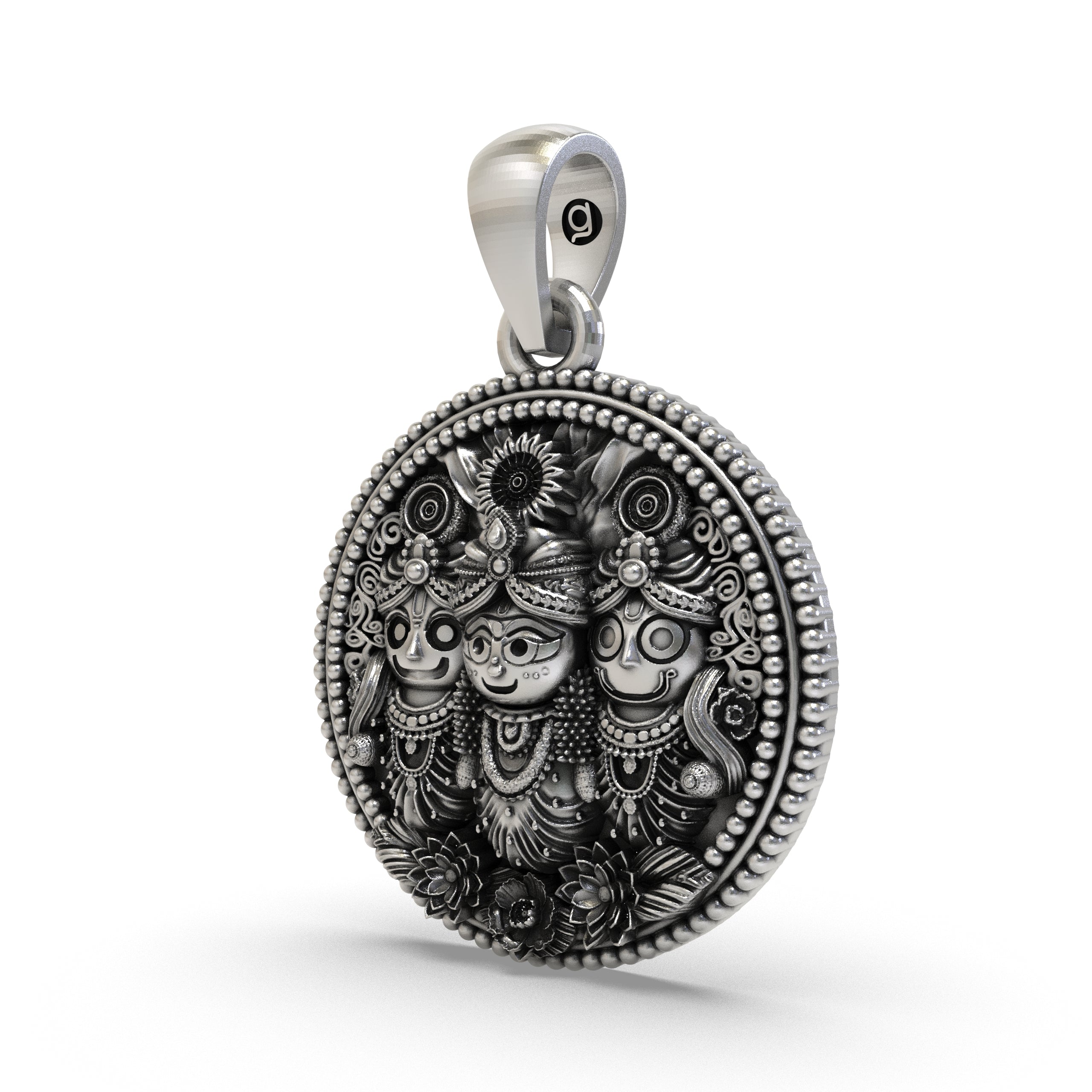 Close-up detailing the carved trio of Lord Jagannath on this sterling silver medallion.